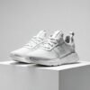 Designer Luxury Sneakers - High-End Pair on White Pedestal with Dramatic Lighting